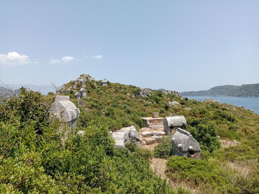 Half-submerged Lycian sarcophagus on the shore at Kaleköy